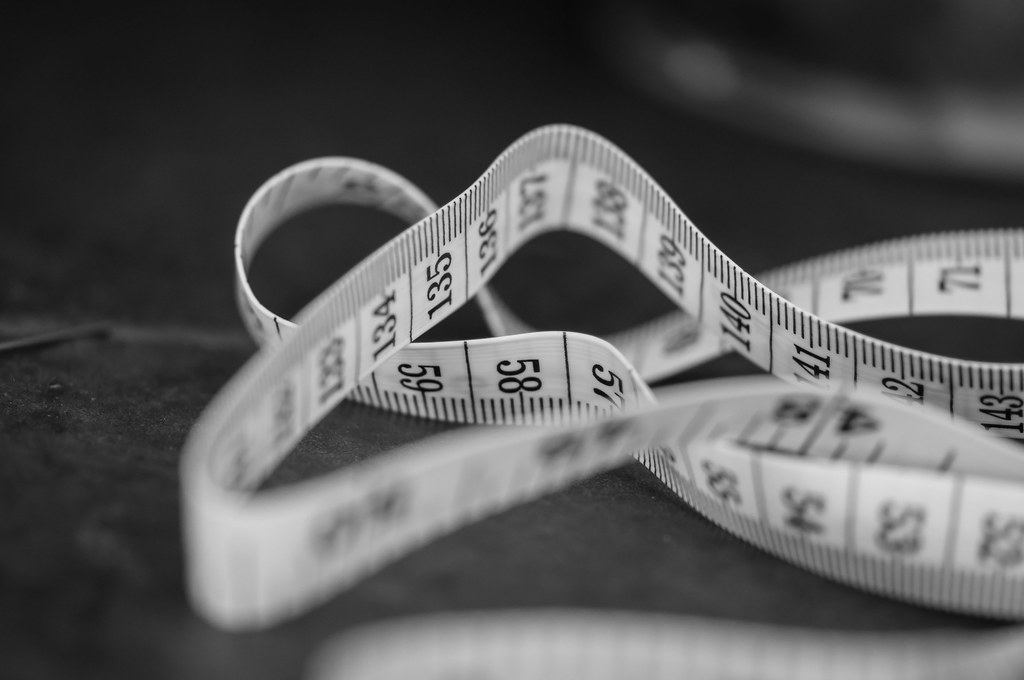Woman measuring her waist to track CitrusBurn weight-loss progress over time